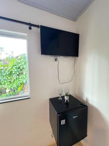 a room with a black refrigerator and a window at Pousada Oxente Uai! in Pirenópolis +50 photos