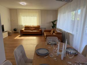 a living room with a table and a couch at Haus 87a Apartment 2 in Oberkirch