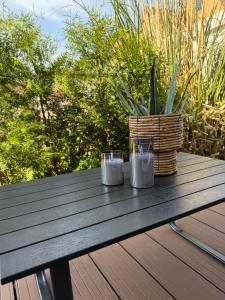 a picnic table with two candles and a basket on it at Haus 87a Apartment 2 in Oberkirch