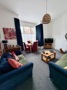a living room with a couch and a table at Alfie's Den, Bridlington in Bridlington