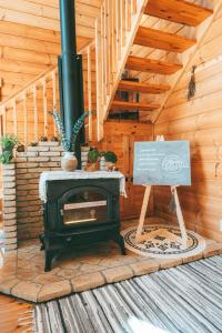 a wood stove with a sign in a cabin at July In Furano in Nakafurano