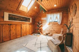a log cabin with a room with wicker chairs at July In Furano in Nakafurano