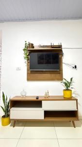 a living room with a tv on a wall at Casa no Vidigal da Nilda in Rio de Janeiro
