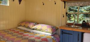 a small room with a bed and a sink at Firbank Park Shepherd Huts in Dinnet +15 photos