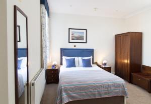 a hotel room with a bed and a mirror at Imperial Lodge in Great Yarmouth