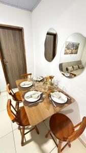 a dining room with a wooden table and chairs at Casa no Vidigal da Nilda in Rio de Janeiro