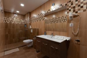 a bathroom with a sink and a toilet and a shower at Central Hotel 21 in Budapest +46 photos