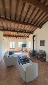 a living room with white couches and a fireplace at Antico Casale Mevania in Bevagna