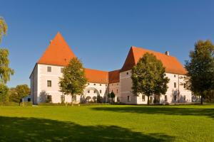 a large white building with an orange roof at Schloss Hotel Zeillern in Zeillern