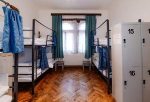 a room with four bunk beds and a window at Hostel Jasmin in Prague