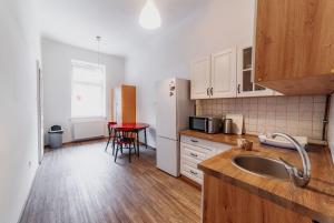 a kitchen with a sink and a table in it at Hostel Jasmin in Prague