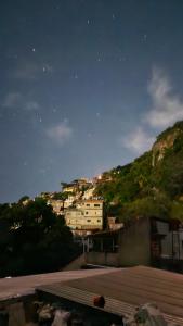 a city at night with buildings on a hill at Casa no Vidigal da Nilda in Rio de Janeiro