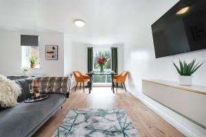 a living room with a couch and a table at Stylish 2-Bed Manning Gardens in South Norwood