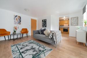 a living room with a couch and a table at Stylish 2-Bed Manning Gardens in South Norwood