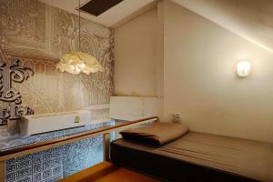a small room with a bed in the corner at Shade House - Phuket Downtown in Phuket +150 photos