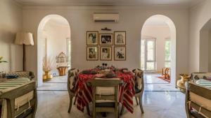a dining room with a table with a red table cloth at Barwara Kothi in Jaipur