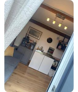 a living room with a couch and a kitchen at Vinnies hideaway in Morpeth +5 photos