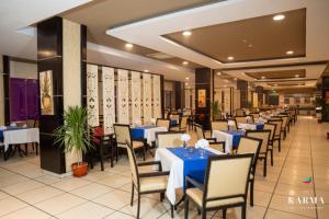 a dining room with blue tables and chairs at Studio at El Karma Beach & Aqua Park in Hurghada
