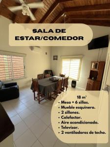 a living room with a table and a dining room at Entre Montañas in Rivadavia