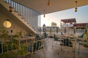 a restaurant with tables and chairs on a balcony at UDAISA - The Luxury Art in Udaipur