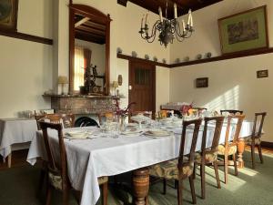 a dining room with a table with plates and glasses at Huize Beukenstein in Lochem +15 photos