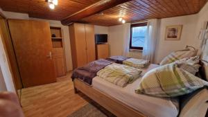 a bedroom with a bed with pillows on it at Ferienwohnung Altrichter in Wabern