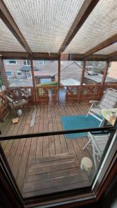 a view of a large wooden deck with a pool and chairs at Ferienwohnung Altrichter in Wabern