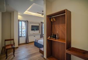 a bedroom with a bed and a television in a room at UDAISA - The Luxury Art in Udaipur