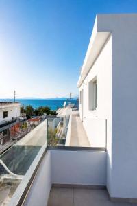 a view from the balcony of a white house at Sinani Apartment - Sea View Balcony & Jacuzzi Gem in Asgourou
