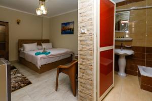 a bathroom with a bed and a sink in a room at locanda pyramids view & Jacuzii in Cairo +64 photos