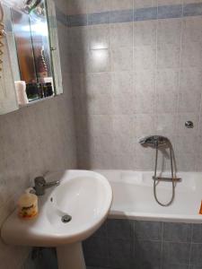 a bathroom with a sink and a bath tub at Hotel Galaxias in Kato Loutraki +31 photos