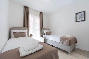 a hotel room with two beds and a window at Hotel Podostrog - New Comfort 2026 in Budva