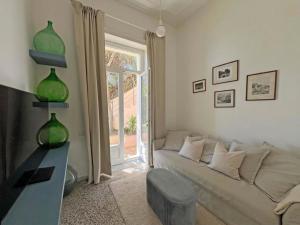 a living room with a white couch and a window at Villa Ipomea - Terra Suite in Salerno +12 photos