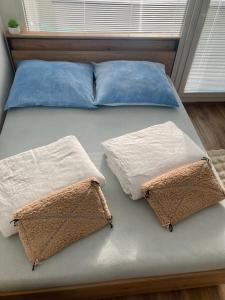 a bed with two pillows on top of it at Apartment Poprad in Poprad