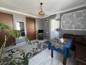 a living room with a table and a couch at Hotel Nestt in Kazbegi