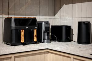 a kitchen counter with two coffins and a printer at Sunny Hill in Palanga