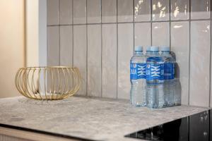 two bottles of water sitting on top of a counter at Sunny Hill in Palanga