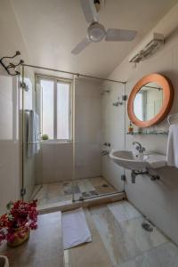 a bathroom with a shower and a sink and a mirror at Barwara Kothi in Jaipur +96 photos