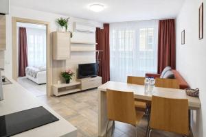 a living room with a dining room table and a living room at Къщата с чешмата in Veliko Tŭrnovo