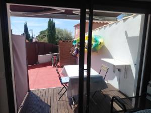 a view of a balcony with a table and a playground at Chez Pierrot 2 in Bandol +3 photos