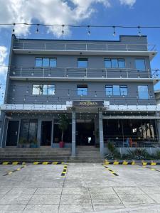 a large building with a parking lot in front of it at Zolaria Hotel and Restaurant in Tagaytay
