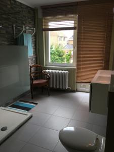 a living room with a toilet and a window at Bella Noche Brugge in Bruges