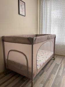 a bed in a room next to a window at Mila 6 in Burgas