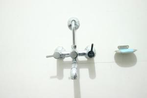 a bathroom sink with a faucet and a bowl at Hotel Golden Mahseer in Tezu +13 photos