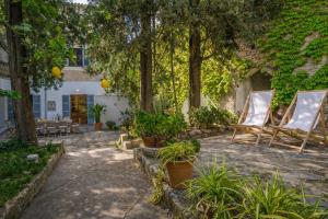 a patio with two chairs and trees and plants at Arta - 4337-73 Mallorca in Artá