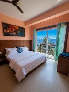 a bedroom with a large bed and a large window at Opal Villas Mussoorie near Mall Road in Mussoorie