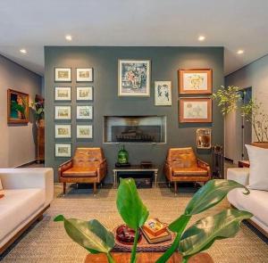 a living room with two couches and a fireplace at Exclusive Oásis by Lotta De Macedo Soares in Petrópolis