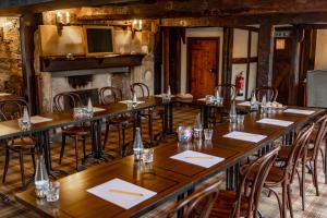 a group of tables in a room with chairs at The Thatch Inn in Gloucester