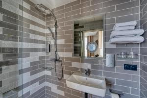 a bathroom with a sink and a shower and a mirror at Hôtel de Bellevue Paris Gare du Nord in Paris +64 photos