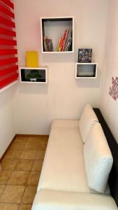 a room with a couch and shelves on the wall at Appartement le Refuge du Cerisier in La Chaux-de-Fonds